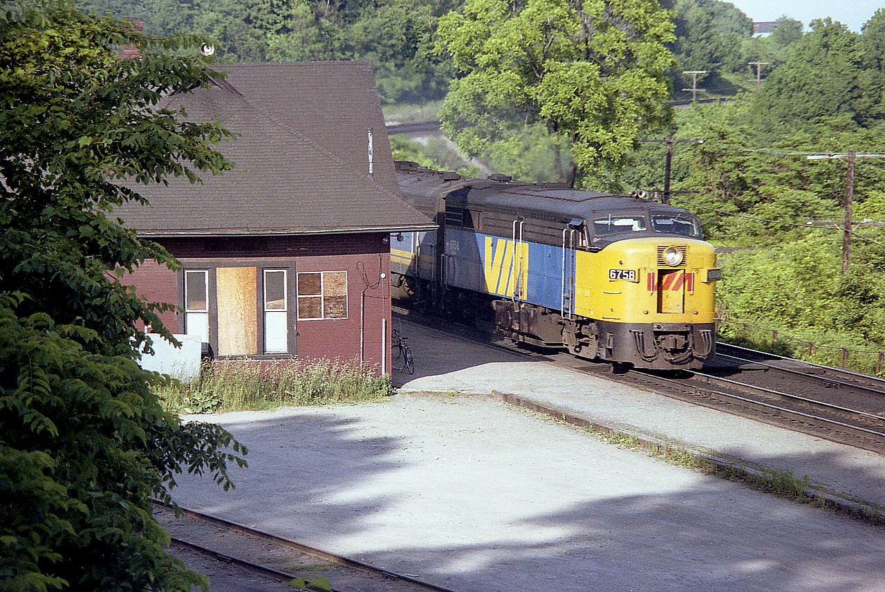 Getting late in the day, but at this time of the year the sun stayed awake for #79, which was due thru here around 8PM regular people time, or 2000 railroad time.
This version is moving along pretty good. It was tough to time it coming out from behind the old Dundas station and I acknowledge I shot it a hair too soon.  Power is VIA 6758, 6622 and 6620.
Too bad we cannot turn back the clock. These years were great for passenger trains along the Dundas. In this case, I just wanted the leader, one of only two MLW FPA-2u, the other being 6759. They were both retired by 1987, and the unit pictured is now on the New York & Lake Erie, still active as far as I know.