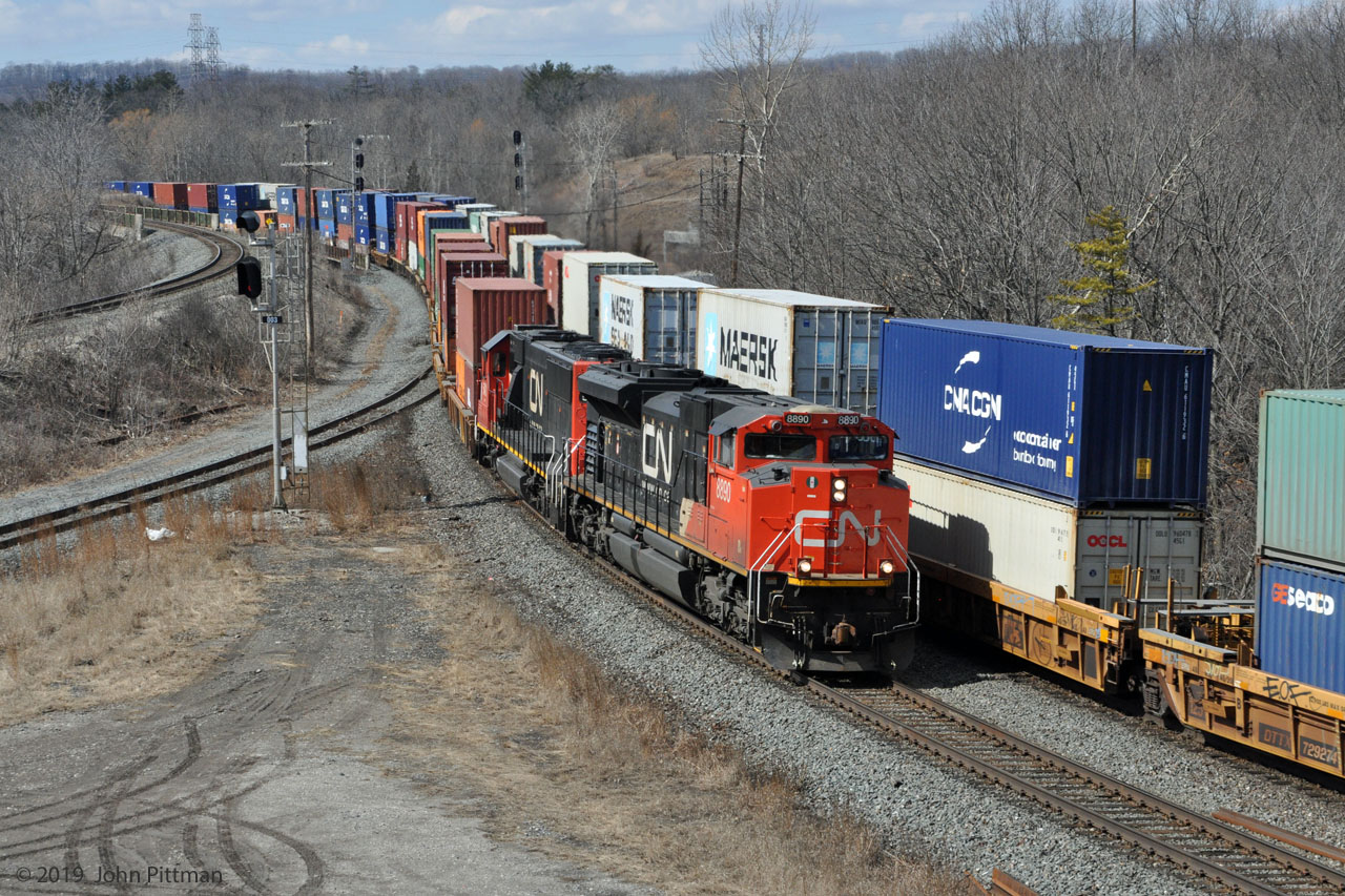 Rarely has CN intermodal train 149 (Halifax - Chicago) turned up when I'm watching the Bayview Jct area.  It was a double surprise to catch it meeting its counterpart train 148 there on 2019 March 19 around 1:43PM.
CN 148 has a GMD SD70M-2 in the lead, second unit is a standard-cab EMD SD60.  
CN 149 was powered by CN 8022 leading (SD70M-2) and GECX 9507 (C41-8W in UP colours, except for CN-painted A/C unit). 
Head ends of both trains crossed near the signals at the bridge over Hwy 403.
Tail ends of both trains crossed near the spot where front of 148 is.