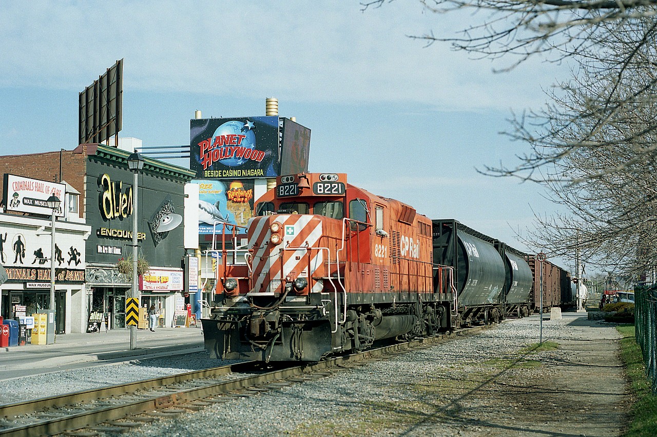 It was approaching the 'midnight hour' for railroad activity in downtown Niagara Falls. This, I think, was the last local I ever saw rolling thru here; the track was soon to be lifted as CP was pulling out. CP 8221 is seen just crossing touristy Clifton Hill, alongside Victoria Av, on its transfer run from the CN yard back to CP Montrose. There was 10 years difference between this and the CSX photo (#36718) I posted recently, but it would have been neat to imagine a meet between that CSX 8221 and this CP 8221. I wonder if anything like that ever happened along the line here?