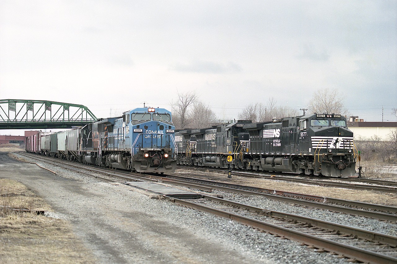 Rather busy looking at Fort Erie as on the right, NS #369 is making a lift of US-bound traffic behind black units NS 9577, 8869 and 9024. Showing at the same time is the Auto Parts train #328 with NS (CR) 8379 and UP (DRGW) 9846, an SD50.  Not often did we see Rio Grande paint in Southern Ontario, and even this one was short-lived. UP retired it by June 15, 2007.
These days, Fort Erie has lost most all of its railroad activity and is pretty well a hit or miss proposition heading down there for photos.  Far cry from 30 years ago.