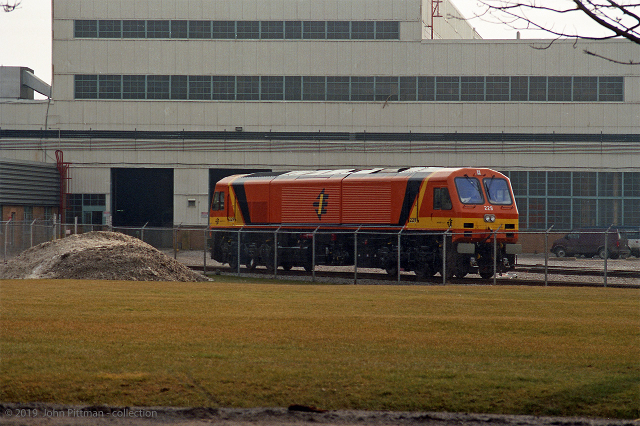 St Patrick is the patron saint of Ireland, and March 17 is his day - prompting this submission. 
New JT42HCW locomotive 229 for Irish Rail (Iarnród Éireann) is pictured outside the GM Diesel Division Plant in London ON. As of 2019 these remain the newest and most powerful locomotives in Ireland. 
The railways of Ireland have a track gauge of 5' 3", wider than international standard gauge which is 4'  8-1/2".  Dissatisfied with previous diesel locomotives sourced from England, Irish Rail ordered their "201 class" of new locomotives from EMD / GM Diesel Division. They were built in 1994 and early 1995 with unit numbers from 201-234, including 2 built for Northern Ireland Railways. 
JT42HCW locomotives are powered by an EMD V 12-710G3B  diesel engine of 3200 gross HP (2970 HP for traction).  These locomotives have the capability of using the prime mover to provide Head End Power for passenger coaches, but problems experienced with this system have ended its use.  Instead a 4000 series HEP control car is typically placed at the other end of intercity passenger trains, the equivalent of GO Transit's former APCU.
In recent years the majority of Irish intercity passenger trains are operated by diesel multiple units, an exception being Cork-Dublin services which are generally locomotive hauled. I saw several 201-class locomotives on passenger trains at Cork station in 2015, in a different colour scheme. JT42HCW locomotives also power freight trains in Ireland.
Location mapped is approximate, date might not be exact.