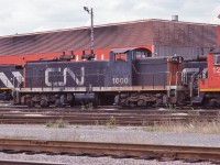 <br>
<br>
 CN Class GR-12m, CN #1000
<br>
<br>
 GMD 1958 built GMD1 with as ordered A-1-A trucks
<br>
<br>
  CN 1000 series unit(s) designed /  intended for light rail branchline assignments.
<br>
<br>
 Sept   8 1983 at CN Thornton Yard, Surrey B.C.,  Kodachrome by John Baker, collection of Steve Danko 
<br>
<br>
 What's interesting
<br>
<br>
  A trio of 1000's series GMD-1 regularly worked the Scarborough Junction yard and  the CN Uxbridge Subdivision Scarborough - Lindsay – Peterboro run throughout the late 1960's; by late 1970's MLW RS18's worked the line, then rebuilt GMD GP9's
<br>
<br>
  per Trackside Guide, rebuilt 1989 with B B trucks at Pointe St. Charles  and renumbered CN#1423 Class GR-412a
<br>
<br>
 GMD1u CN#1423 has worked throughout the CN system, from Saint John to Oakville to Sault Ste Marie to Fort Saskatchewan to Edmonton – try searching CN 1423
<br>
<br>
sdfourty
