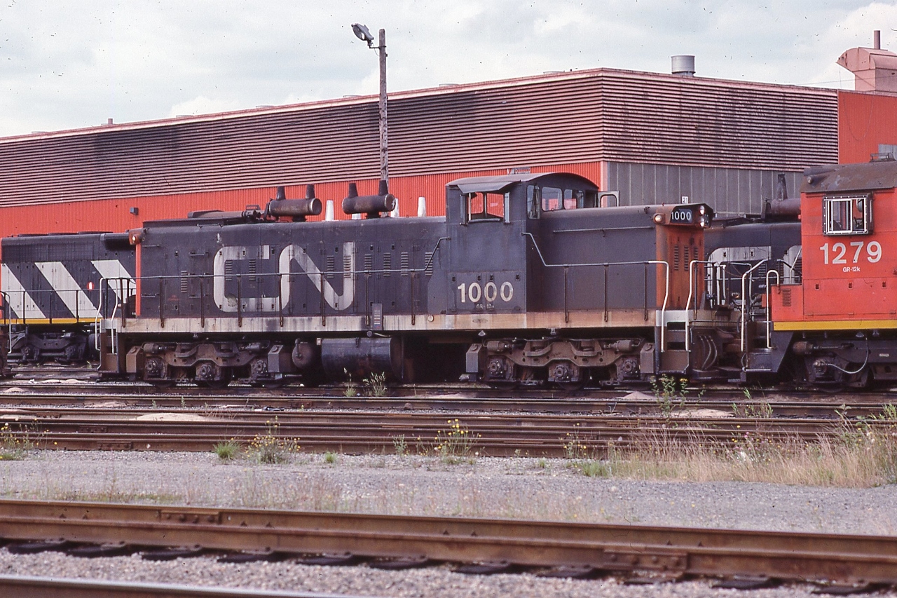 CN Class GR-12m, CN #1000


 GMD 1958 built GMD1 with as ordered A-1-A trucks


  CN 1000 series unit(s) designed /  intended for light rail branchline assignments.


 Sept   8 1983 at CN Thornton Yard, Surrey B.C.,  Kodachrome by John Baker, collection of Steve Danko 


 What's interesting


  A trio of 1000's series GMD-1 regularly worked the Scarborough Junction yard and  the CN Uxbridge Subdivision Scarborough - Lindsay – Peterboro run throughout the late 1960's; by late 1970's MLW RS18's worked the line, then rebuilt GMD GP9's


  per Trackside Guide, rebuilt 1989 with B B trucks at Pointe St. Charles  and renumbered CN#1423 Class GR-412a


 GMD1u CN#1423 has worked throughout the CN system, from Saint John to Oakville to Sault Ste Marie to Fort Saskatchewan to Edmonton – try searching CN 1423


sdfourty