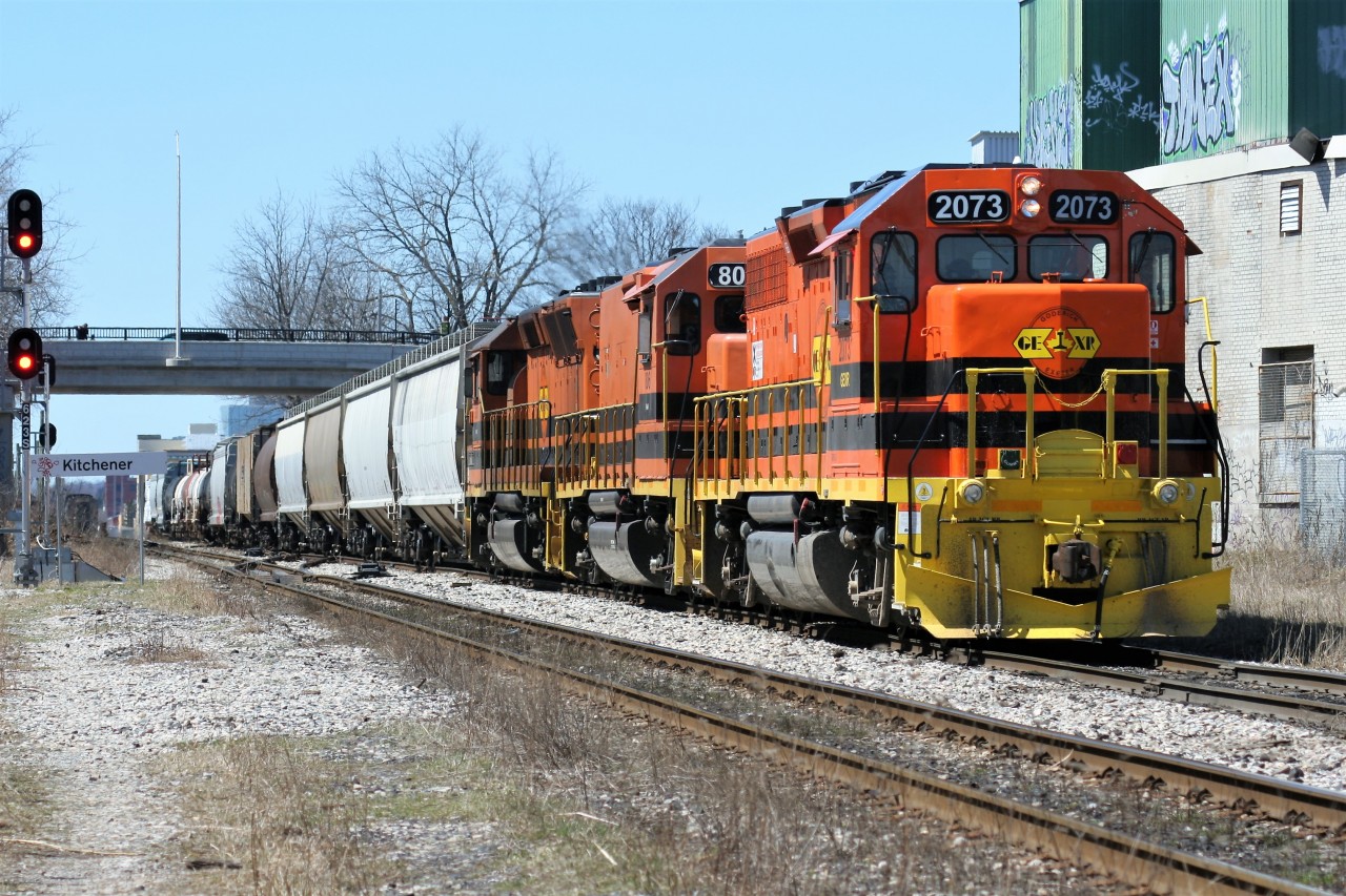 After meeting VIA Rail train 85, pictured in the background at the Kitchener station, Goderich-Exeter Railway (GEXR) train 516 is viewed in the siding slowly approaching the yard, where it will set-off and lift cars before returning westbound to Stratford. The consist includes; GEXR GP38-3 2073, SLA RM-1 806 and SLA GP40-3 3806.