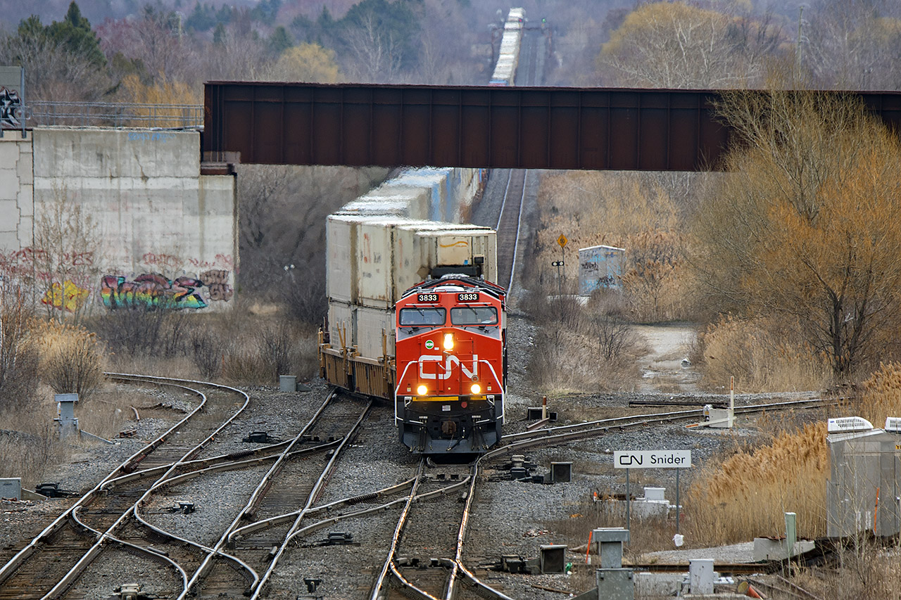 An enormous 114, the back end still emerging from the Yonge St cut starts through the crossovers on the way to BIT