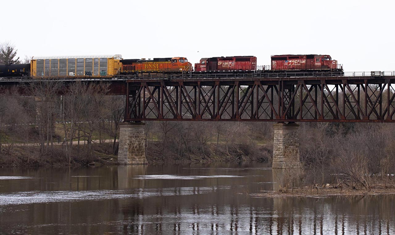 10 years ago, BNSF 5493 would have been the highlight ( or finally meeting Mr. Host). But today, nostalgia rules as 6028 and 5935 descend onto the Grand River bridge as they have done for the last 35+ years. I never thought I'd see SD40-2's leading on CP again( and sure they look a little worse for wear in CP's worst paint scheme; sweating the assets is still key), but a hot tip made this possible. Thanks Isaac
