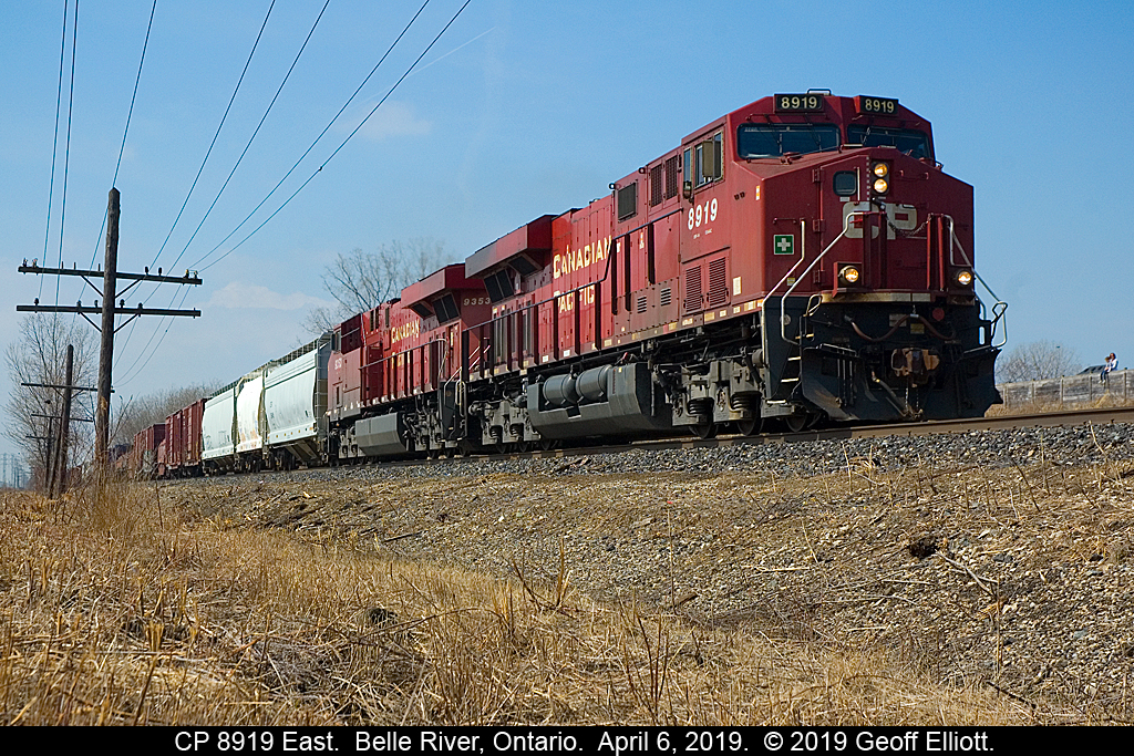 The crew of CP 8919 East gives a wave and a couple 'toots' to my wife and son as they look on from our backyard as the train rolls through Belle River on April 5, 2019.
