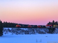 At sunrise, CN Q120 begins it's climb towards Evans, seen here passing Palmers Pond at Dorchester, New Brunswick. 