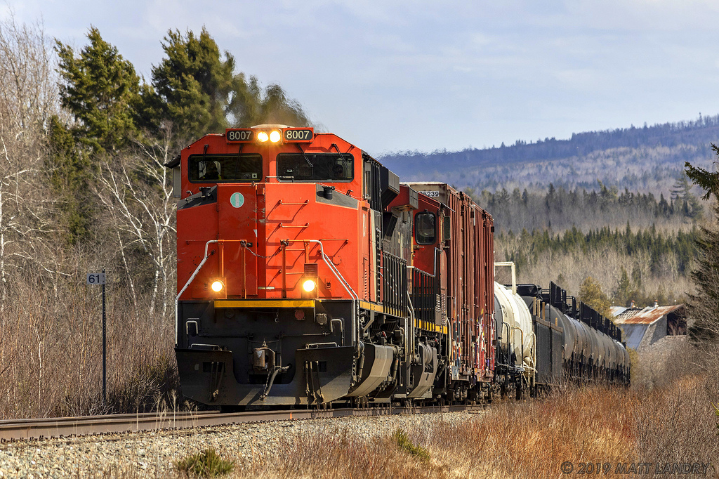 One of the few CN engines missing it's front noodle, CN 8007 leads train 406, as they approach Passekeag, New Brunswick, on a warm Spring afternoon.