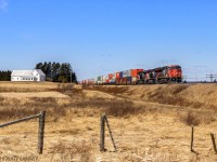 After heading along the Tantramar Marsh, stack train Q120 is about to cross the New Brunswick/Nova Scotia border, approaching Fort Lawrence, NS on a beauty of a day. 