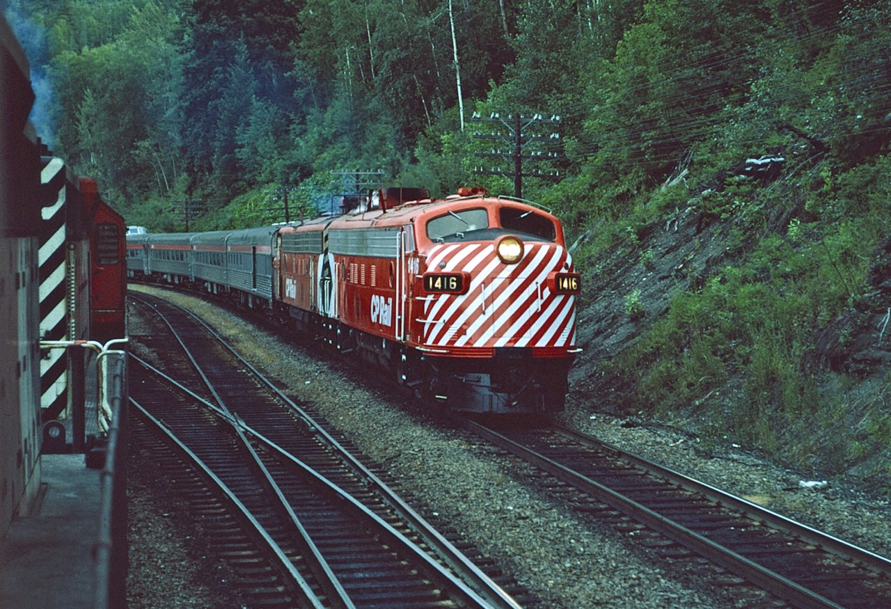 Not long out of the paint shop, CP 1416 shines even under overcast skies, as she leads The Canadian out of Revelstoke BC. Awaiting the passage of No.2, 606,an empty sulpher train, will follow 2 east.