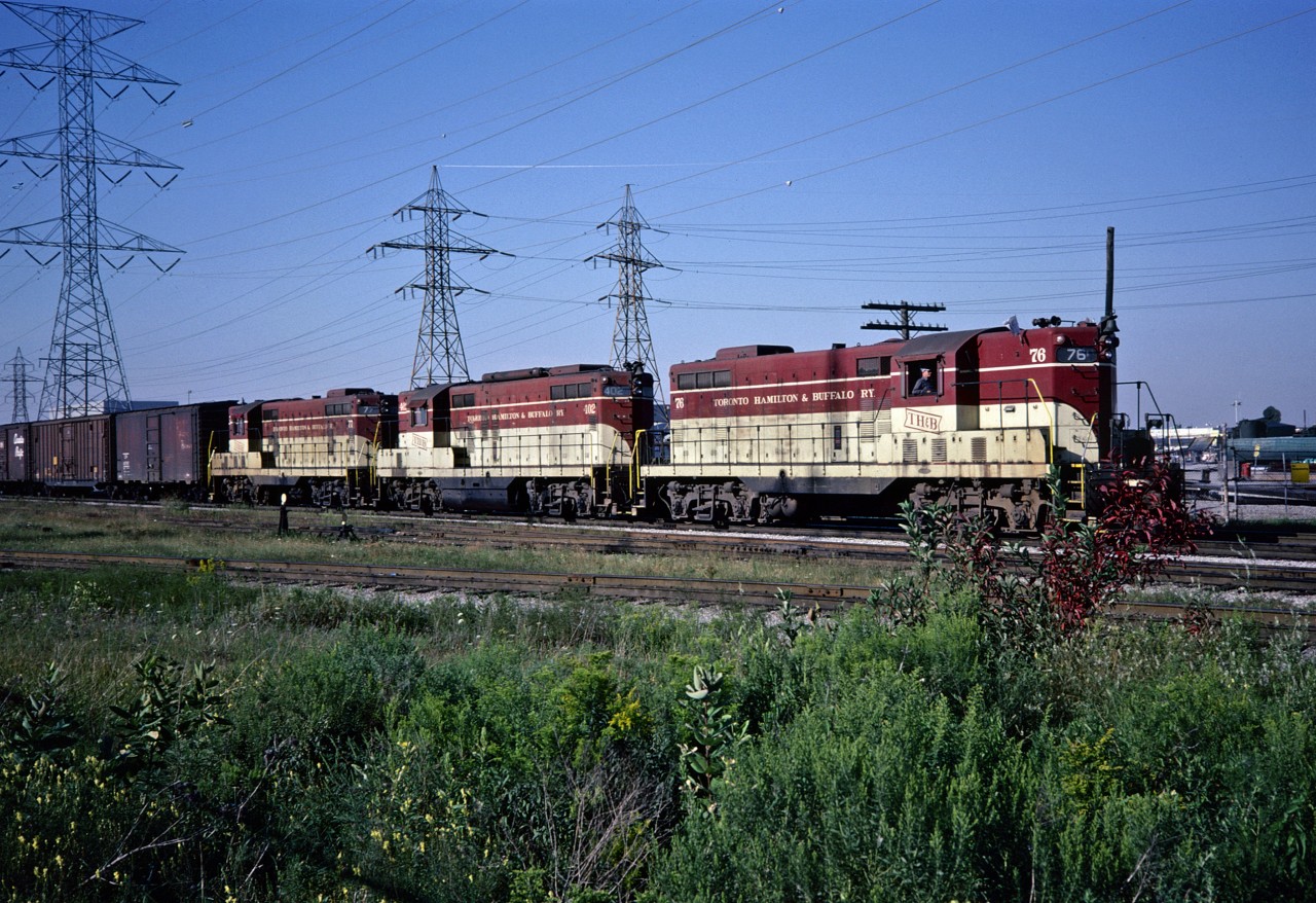 Under beautiful August skies, the Hamilton bound Starlite awaits the light to enter the CN Oakville Sub. The train is just south of the Obico Yard on CP's Canpa Sub.