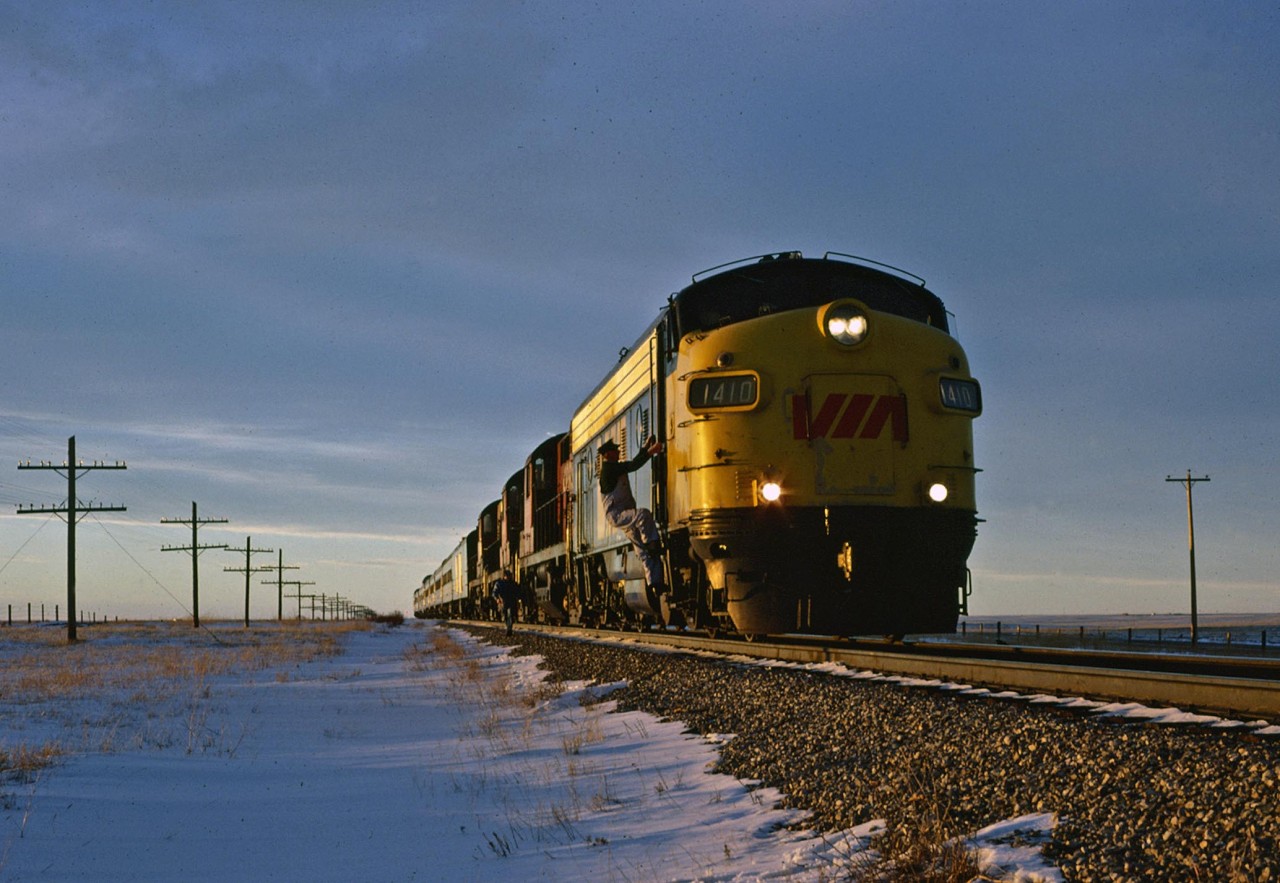 As the sun gets ready to set on a glorious western day, locomotive engineer Reg Avery climbs back aboard the lead unit of the Canadian. He and his fireman, who is just behind him have checked the running gear of the 3 trailing RS10's after the hot box detector at MP 30.8 broadcast an alarm.  Everything checked okay, and the train was soon on its way to Medicine Hat.