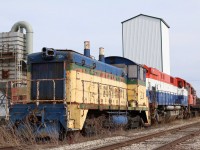 Relics at Mount Elgin. There is a lot of history packed into the week choked siding at Mt. Elgin. A trio of old retired locomotives now serving as little more then a parts source slowly rust away in the elements. SW9 #L3 better known as OSRX #52 began life back in 1951 as C&O 5242. It later went to the L&PS before coming to the OSR. Trailing M420 646 started out on the British Columbia Railway in 1973, spending its entire active life there before coming to the OSR. RS23 506 sits well picked over on the other end. It last worked for Tembec as #179. It should have been numbered OSRX 507 before being delivered but it would seem that as it was only purchased for parts it somehow ended up being numbered as the second 506 on the OSR’s current roster. The Cargil elevator behind sadly closed a few years ago and is no longer an online customer.