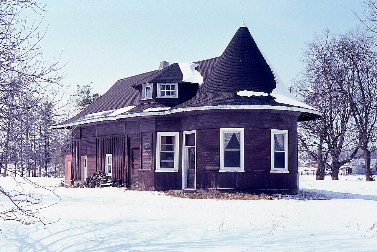 This old station was part of the London, Huron & Bruce railway, which ran from London thru to Wingham. The line north of Clinton was in later years no longer profitable and the last train ran over it Apr. 26, 1941. The station was purchased by a town resident just for the nostalgia of it; and at one time it looked far worse than this image shows, after a nice coat of paint freshened it up. Eventually it was bought for a permanent residence, renovated with brick added as well; and became a Bed and Breakfast. This "witches hat" station is a real treasure from the past.