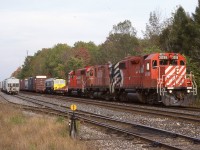 It’s hard to believe this shot was taken almost 20 years ago now. Knowing the the days “Ham Turn” was on its way and not expecting anything special on the head end I headed for the tight but scenic bridge shot in Carlisle. Once I saw the consist though the chase was on as I raced for Guelph Jct. On the head end this day was control cab set 3096 / 1102, a GP38 and de-engined C424, with GP40 4657 trailing. Basically in this configuration this day the C424 was just dead weight. Trailing the power though was a brand new “ Freightliner “ unit destined eventually for England and built in London, Ontario. The unit was taking the exceptionally long, scenic route from Chicago back to the GMD plant in London, after spending some time on display at a show there. I’m still not sure why the routing took it through Buffalo rather the Windsor before making it home.