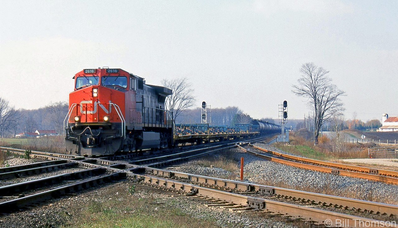 CN C44-9W 2616 leads a freight eastbound over the diamond at "Melrose" (Mile 12.2), on the Strathroy Sub just outside of Komoka. The train is crossing over CP's Windsor Sub mainline, with the connecting track between the two lines visible on the right.