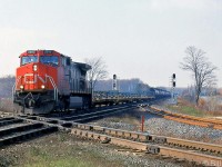 CN C44-9W 2616 leads a freight eastbound over the diamond at "Melrose" (Mile 12.2), on the Strathroy Sub just outside of Komoka. The train is crossing over CP's Windsor Sub mainline, with the connecting track between the two lines visible on the right.