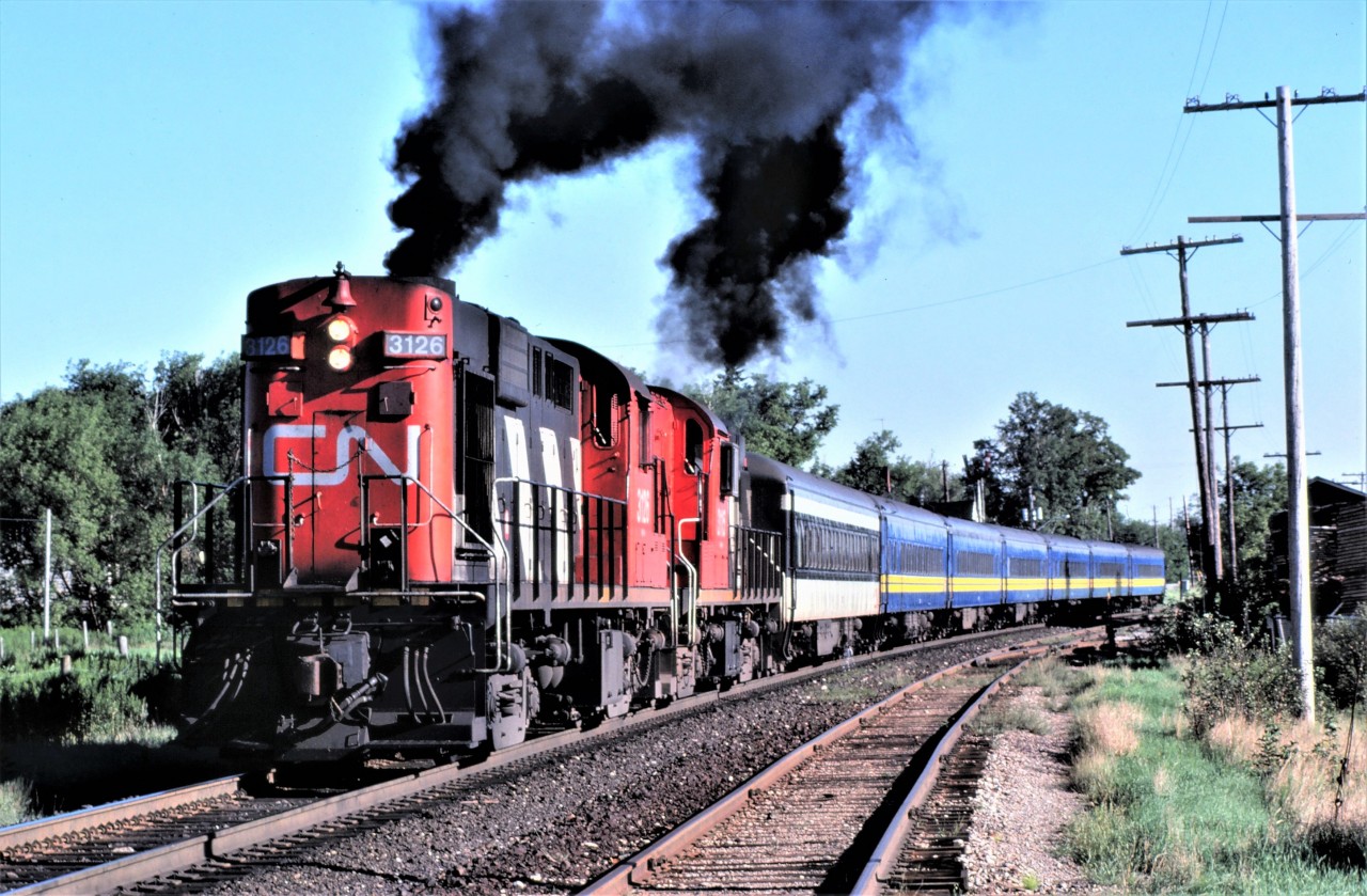 CN train 169, otherwise known as the Barrie Commuter, accelerates out of Maple, Ontario after making its station stop.  A pair of MLW RS-18s, 3126 and 3115, put on a fine show!