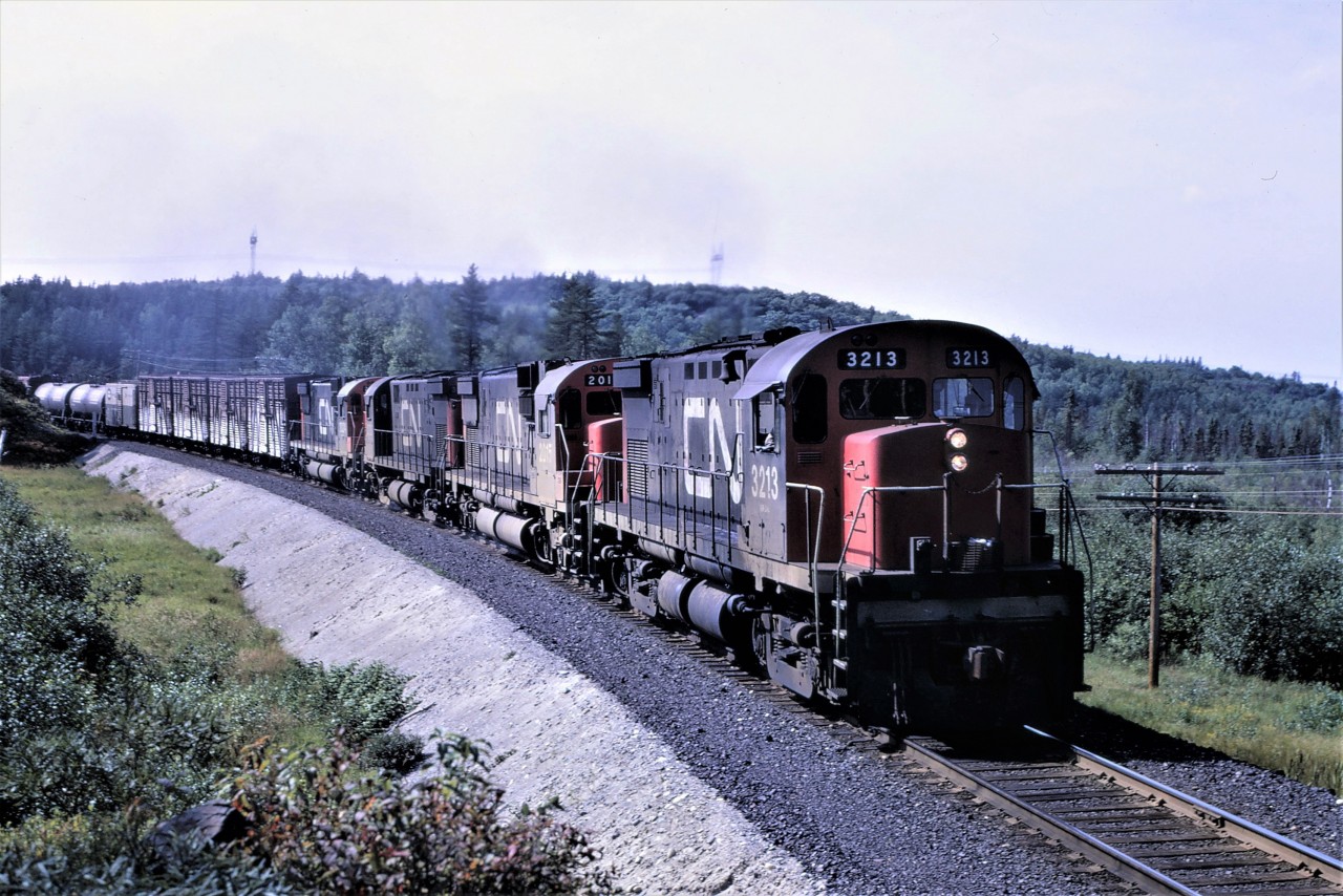 September 6th, 1970 sees train 308, running as time table train 894, heading east out of Capreol, Ontario on the now abandoned Alderdale Sub.  Power for the train is C424 3213 C630 2015 C424 3227 and along for the ride a dead C630 2024.  Actual location is about 3 miles east of Capreol.