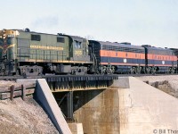 CN RS18 3855 leads two leased Bessemer & Lake Erie F-units on a freight heading over the Cooksville Creek bridge around Mile 11.8, to the west of "Lakeview" on CN's Oakville Sub. CN had a number of B&LE 700-series F7A's and F7B's <a href=http://www.railpictures.ca/?attachment_id=29642><b>on lease in the mid-60's</b></a>, as did <a href=http://www.railpictures.ca/?attachment_id=17031><b>CP</b></a>.<br><br>The Lakeview mileboard/station name sign was to the east of here at Mile 11.1. The area had a few sidings to a Department of National Defense facility off Cawthra & Atwater, as well as a long spur to the Ontario Hydro/HEPC Lakeview Generation Station. It disappeared from CN timetables sometime between 1965 and 1967, replaced by the new "Port Credit East" at Mile 11.5.