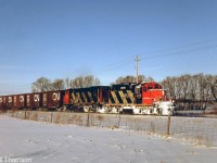 CN GP9RM 4116 and HR412 3583 work a local freight southbound on the Exeter Sub, approaching Highway 83 (presently Thames Road West) crossing at the north end of the town of Exeter in February 1988.