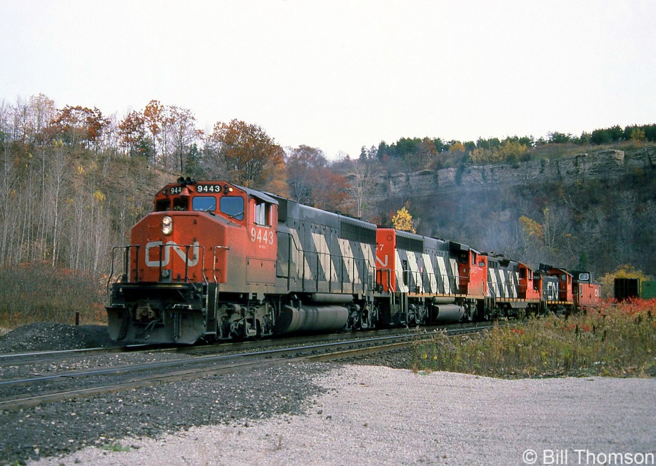 A westbound CN freight heads through Dundas with GP40-2LW units 9443 and 9457 leading a GP9, SW1200RS and van on the head end.