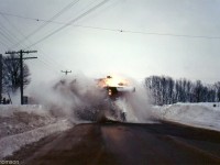 A CN snowplow train blasts through the plowed-in crossing snowbanks, heading north from Hanover on CN's Owen Sound Sub. It was 5:15pm and already getting dark out when this winter evening shot was taken.