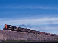 Four RS18s and an RS10 (3661, 3087, 3675,3657, and 3726) lead a westbound up and over the CP Galt sub in Milton on a fine June 1965 day. Note those ice-cooled refrigerator cars up front, returning to the United States!