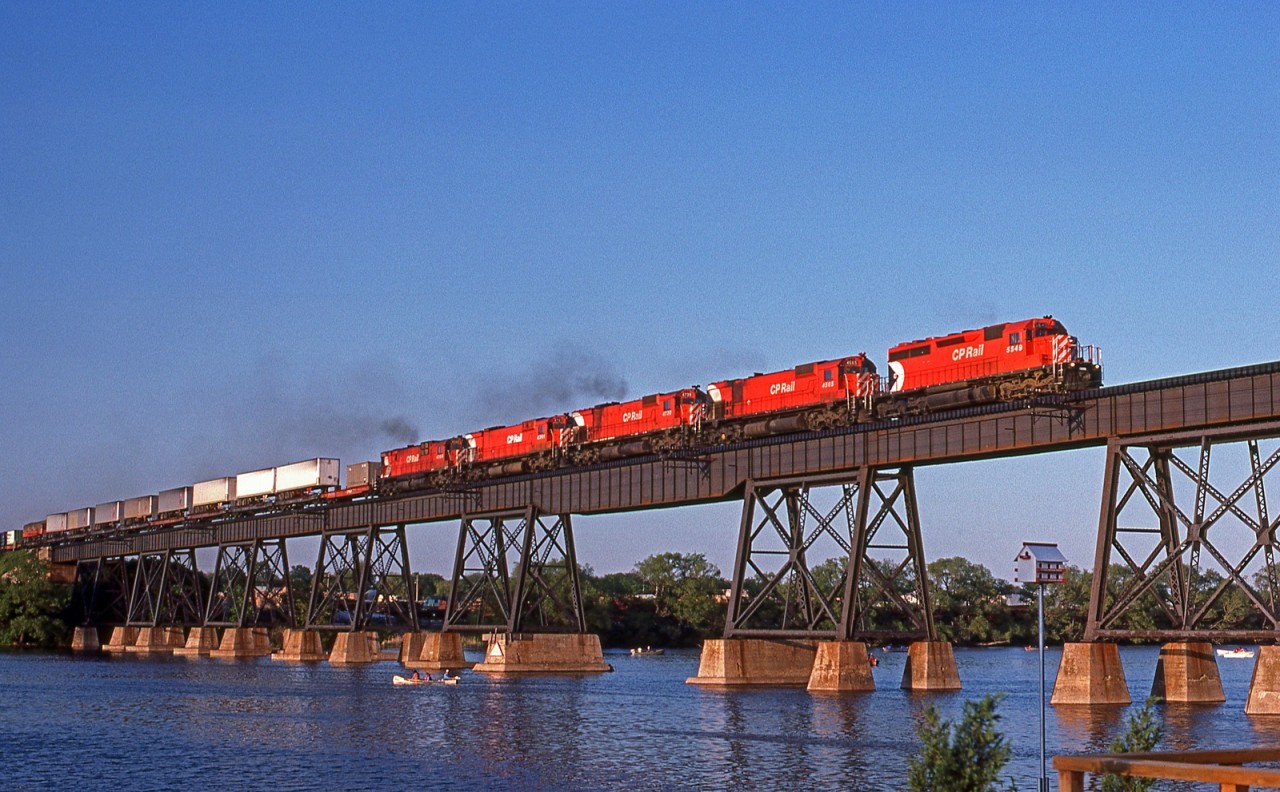 Elephant style in the low evening sun, CP 5549 and helpers 4565,4739,4741,4720, lead a westbound across the Trent River at mile 102 on the CP's Belleville Sub.