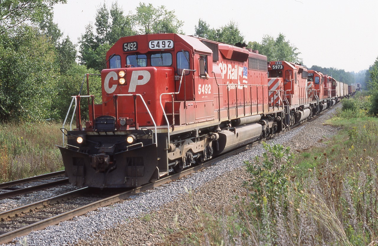 Here is one of those second hand SD40 rebuilds with quite a history, CP SD40M-2 5492 started life as C&O 7531built as a non-Dash-2 SD40, it eventually was renumbered to CSX 8390 before being retired and sold to NRE and renumbered 8390. It later went to Morrison Knudsen and was again renumbered MKCX 9418, In 1995 MK upgraded it into a Dash-2 and sold it to CP. It remained on CP's roster until 2012 when it was retired. Here it is seen leading train 167 into Guelph Jct. on a pleasant July day with three other SD40-2's trailing.