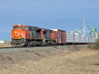SD70M-2 CN 8024 and DASH 8-40CW CN 2186 (Ex BNSF) head east through Viking with lumber and other commodities.
