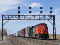 CN 8888 leads a 153-car CN 310 underneath a classic signal gantry on CN's Kingston Sub. DPU is CN 2279.