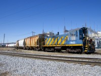 Ex-Port of Montreal SW1001 AXLX 7602 shoves a lengthy cut of cars into the Axiall Canada Inc. plant (formerly PPG Standard Chemical). In the foreground is CSXT's Montreal Sub, just a few seconds later a pair of CSXT GP38-2's would pass by here with a cut of loaded centrebeams.