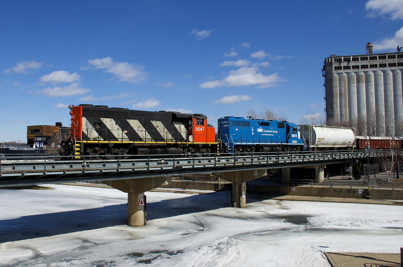 CN 9547 and GMTX 2250 are both running long hood forward as they lead a 19-car transfer into the Port of Montreal.
