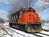 After bringing in cars to the Port of Montreal, CN 9547 is leaving light power as it passes an out of use siding at left.