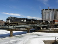 A trio of NS units (NS 7582, NS 9579 & NS 1147) is operating as CN 596 as it brings CN 148 with 206 platforms into the Port of Montreal.