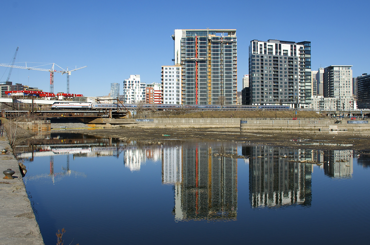 A week after visiting Montreal, AMTK 145 is back in town as it pushes the Adirondack past the Peel Basin on a windless and sunny morning.