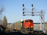 CN 8818 is one of a handful of CN SD70M-2's missing the noodle on its nose, here it is seen leading CN 310 underneath a signal gantry in the St-Henri neighbourhood of Montreal. DPU on this train is CN 2316.