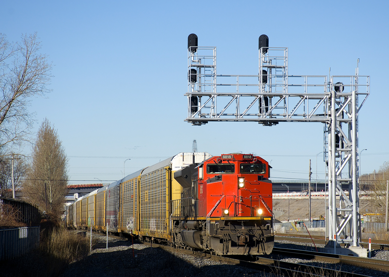 CN 8818 is one of a handful of CN SD70M-2's missing the noodle on its nose, here it is seen leading CN 310 underneath a signal gantry in the St-Henri neighbourhood of Montreal. DPU on this train is CN 2316.
