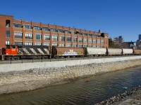 CN 9547 shoves 6 loaded grain car towards the Ardent mill, the last client remaining on the East Side Canal Bank Spur. It is passing what was once a Stelco plant, but is now condos.