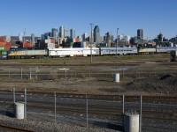 VIA 6433 is up front and VIA 6440 is mid-train as the combined VIA 601/603 passes Montreal's skyline not too long after leaving Central Station, on its way to northern Quebec. At Hervey Jct the train will split, with the first half going to Jonquière and the second half going to Senneterre.