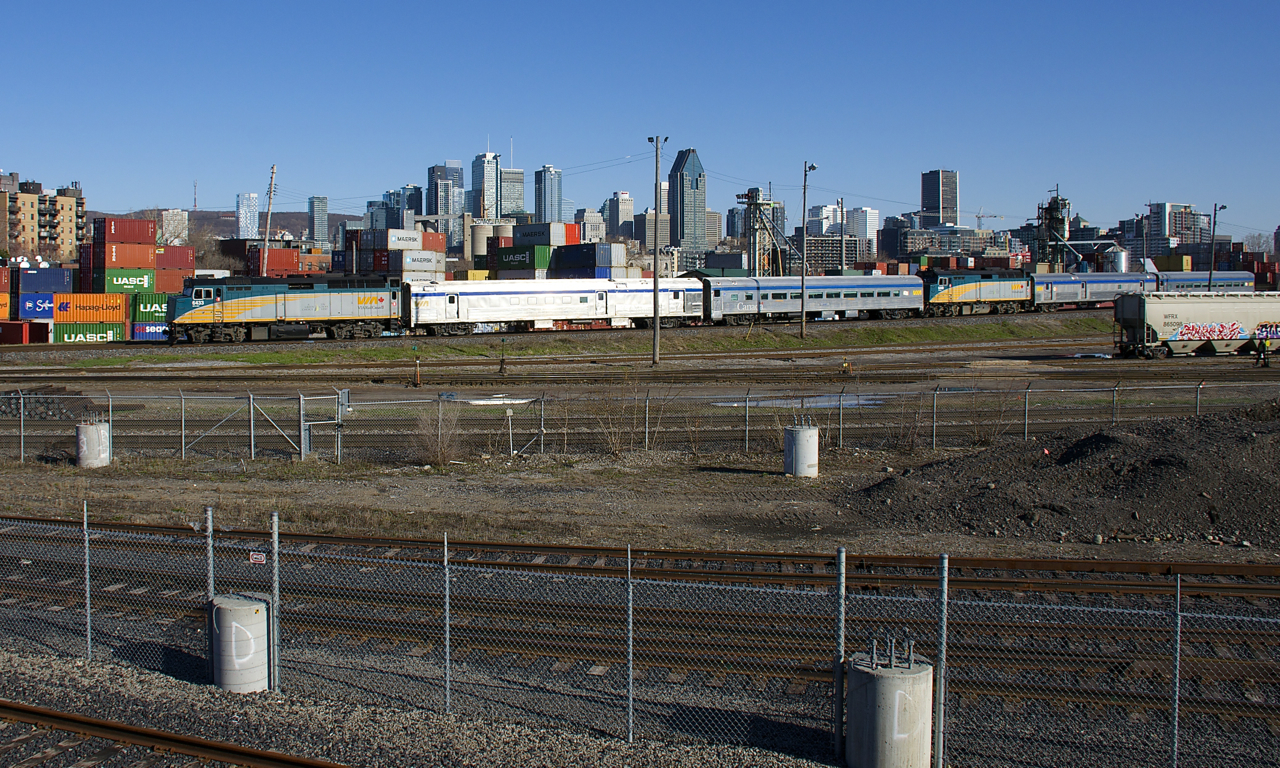 VIA 6433 is up front and VIA 6440 is mid-train as the combined VIA 601/603 passes Montreal's skyline not too long after leaving Central Station, on its way to northern Quebec. At Hervey Jct the train will split, with the first half going to Jonquière and the second half going to Senneterre.
