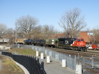CN 310 has a relatively fresh leader (CN 3145) as it approaches the Pointe St-Charles Yard on a sunny morning. Operating mid-train is CN 3084 on this 167-car train. 