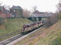 This image is of TH&B 77, 403 and 73 heading toward Kinnear, about to enter the Hunter St tunnel, as seen from Queen St. 
In 1995 changes to this area where made in order to handle GO double deckers and those higher freight consists.
See a similar image taken in 1995 at:  http://www.railpictures.ca/?attachment_id=34622

