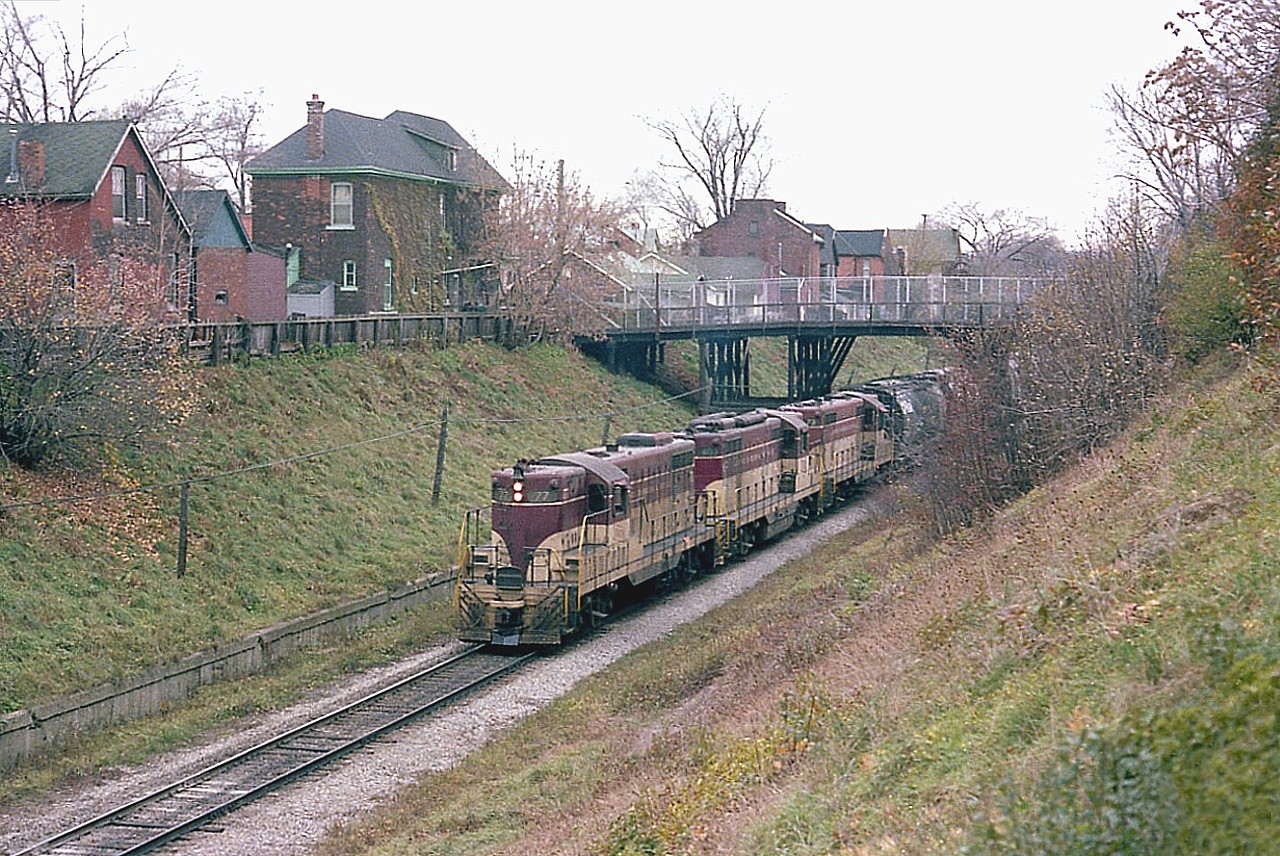 This image is of TH&B 77, 403 and 73 heading toward Kinnear, about to enter the Hunter St tunnel, as seen from Queen St. 
In 1995 changes to this area where made in order to handle GO double deckers and those higher freight consists.
See a similar image taken in 1995 at:  http://www.railpictures.ca/?attachment_id=34622