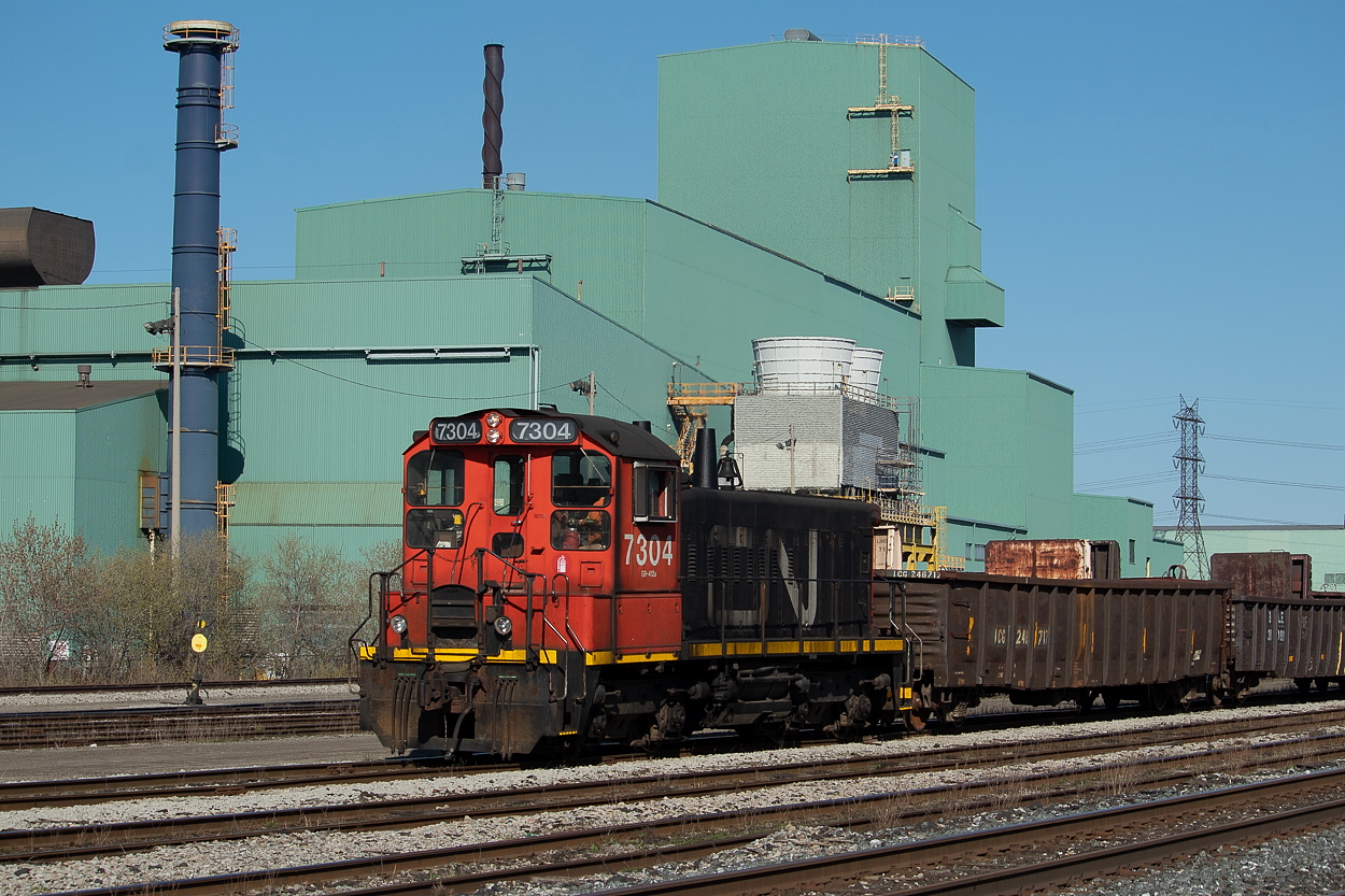 I live in Hamilton, so naturally I have shot 7304 on a number of occasions. I had yet to get a shot of it in decent conditions though. Chalk it up to taking it for granted I suppose - thinking, "I'll get around to it some day; it's here all the time after all."  While I was waiting for 331 on the footbridge I could see two sets of headlights in the distance - one for 331 further away, and the other, closer set for 7304. It could have made for a nice meet shot, but there was no time to make it happen and no telling if gons/coils would have obstructed the view anyways. After shooting 331 I checked out some action in Aldershot quickly, and then made my way back to Hamilton and over to Parkdale Yard to watch 7304 work for a while.