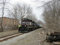 The conductor gets ready to flag the Innisfil street crossing due to inoperative crossing signals.