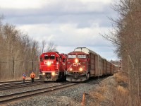 The crew of T69 (CP 3040) depart their train to inspect CP 147 led by a solo CP 8883 hauling 4732 feet of auto racks as it passes them on the south track at the exit of Guelph Junction.