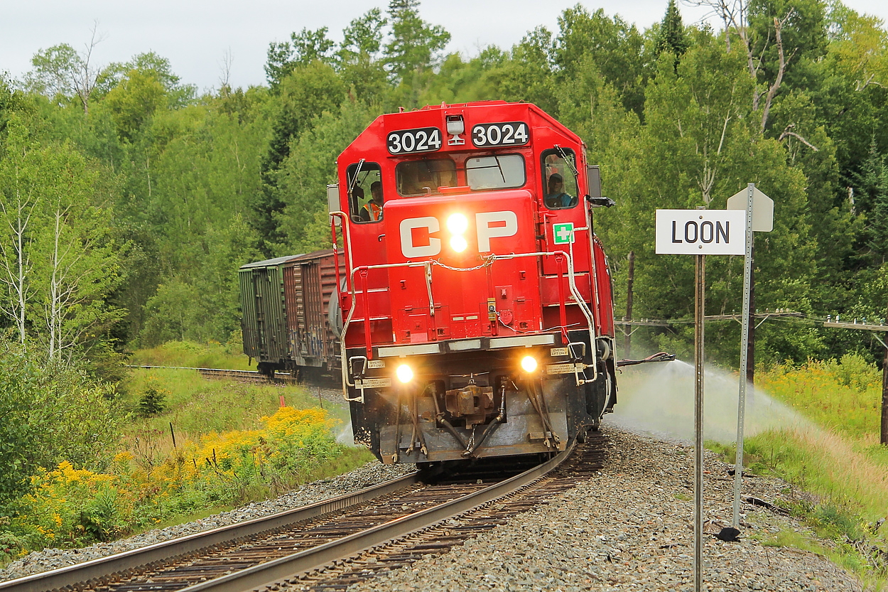 With the CP spray train schedule being released, I was looking back on my encounter from last August when I chased it from Thunder Bay to Loon. I waited at this crossing for some time for them, as they were held on the siding just west of here near West Loon Road to allow 113 to clear.